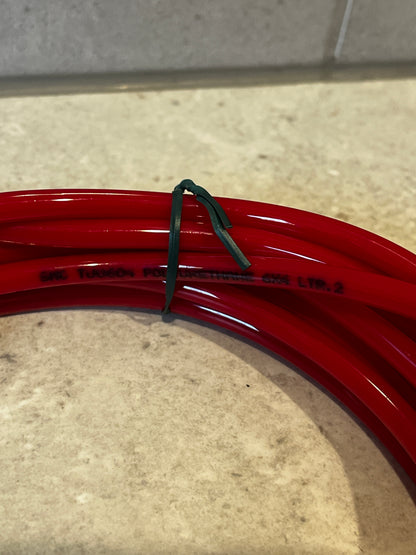 Close-up of red polyurethane tubing coil showing material text