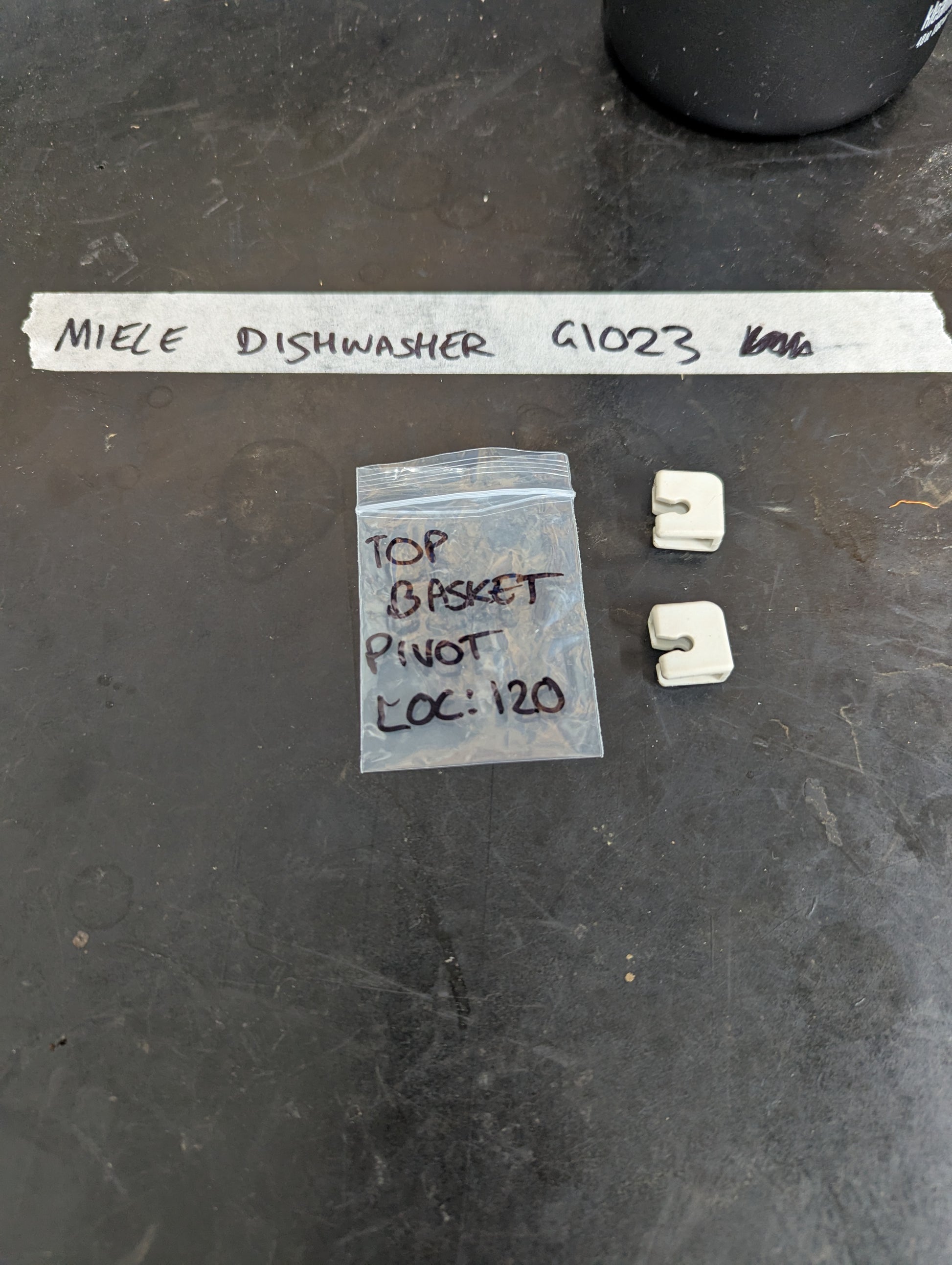 Two Miele dishwasher basket pivot clips with labeled bag for G1023 model