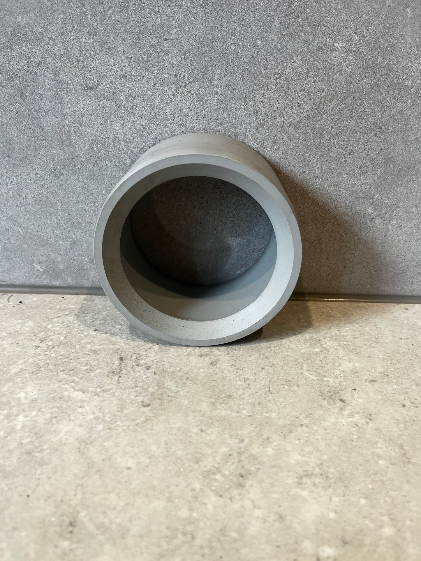 Gray PVC pipe coupling socket adapter angled rear view
