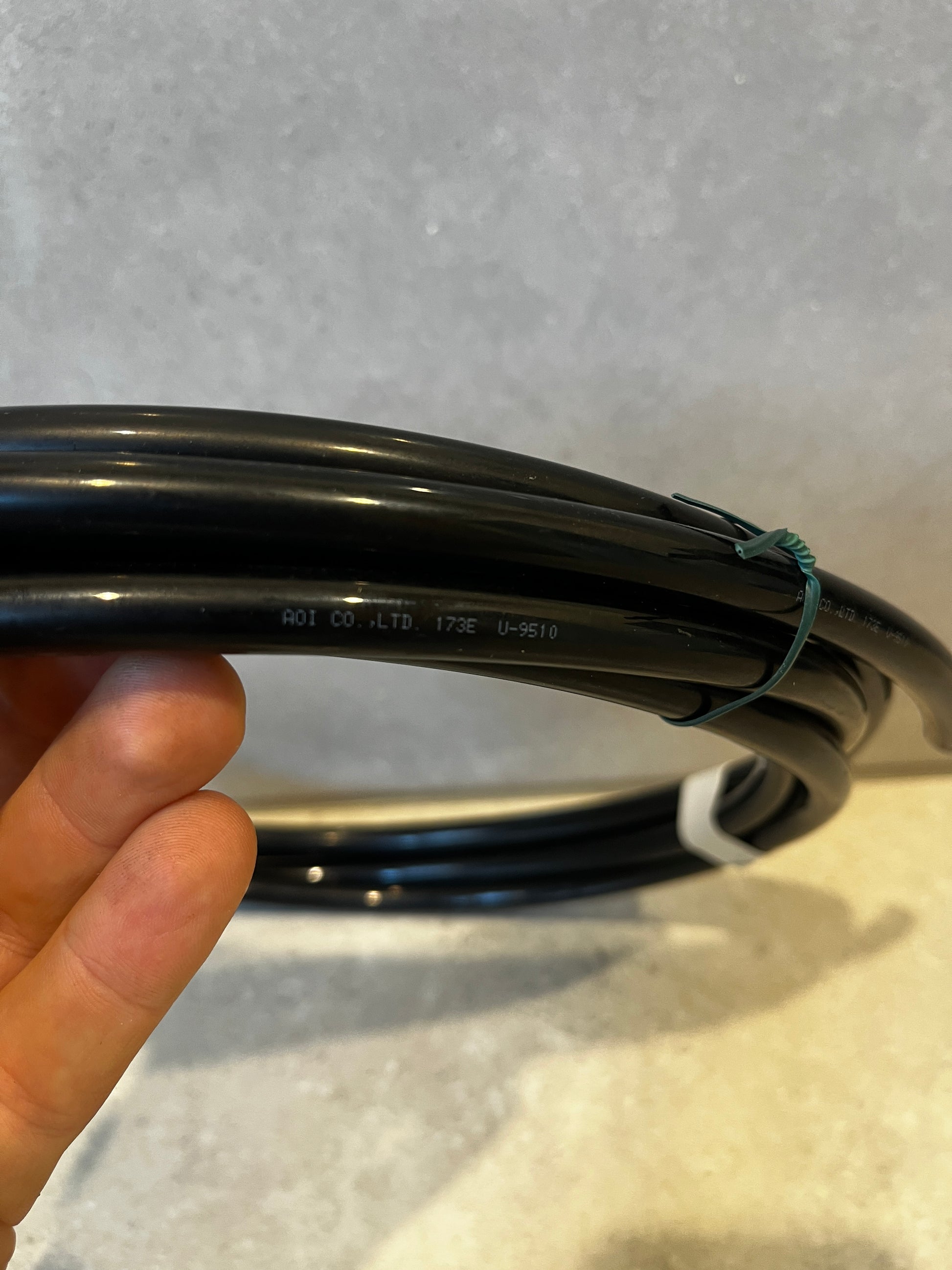 Close-up of AOI black tubing with company label visible