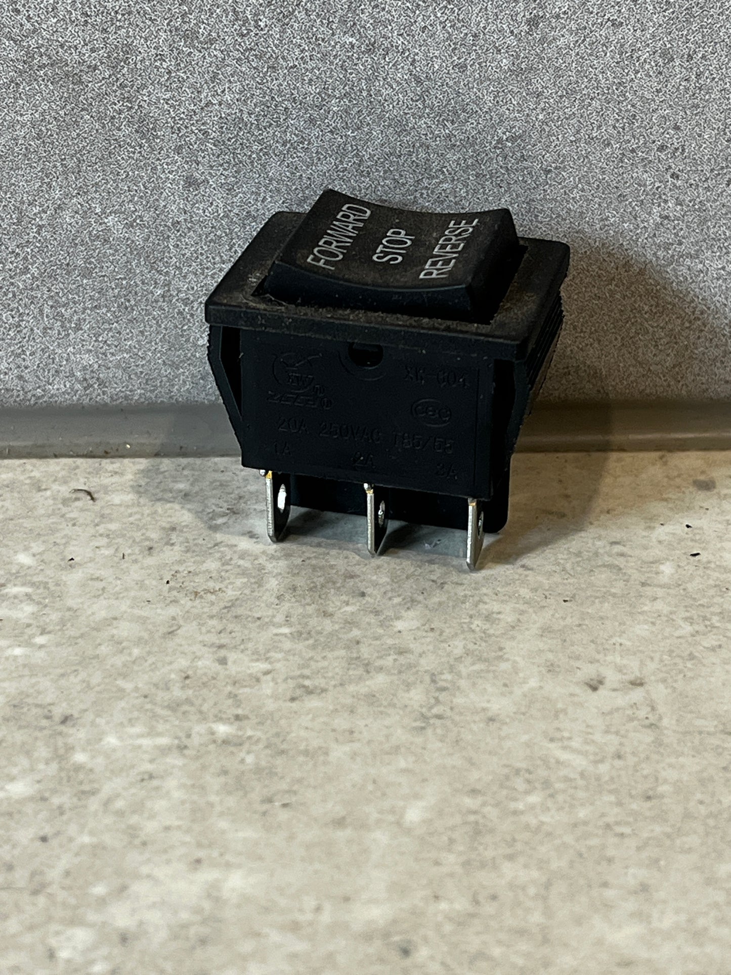 Close-up angled view of Forward Stop Reverse rocker switch showing connection terminals