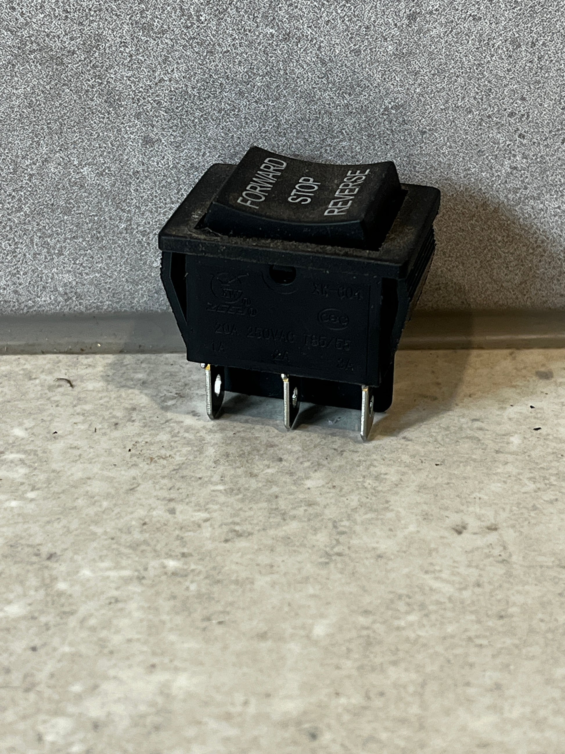 Close-up angled view of Forward Stop Reverse rocker switch showing connection terminals