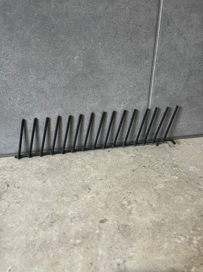 Side view of black metal vertical plate rack for kitchen organization