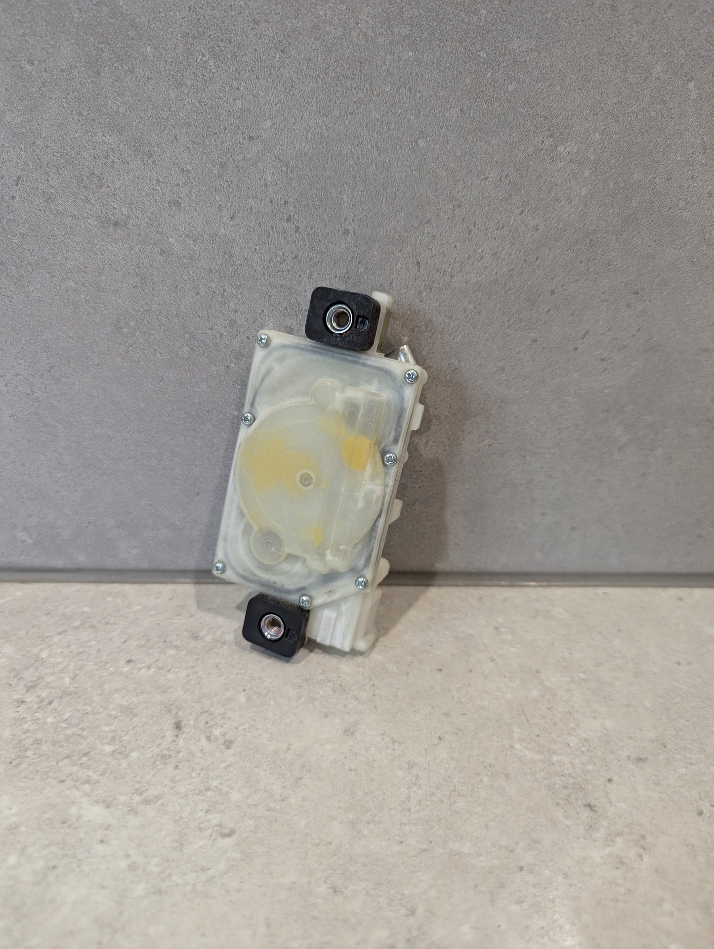 Rear view of Mitsuba door lock actuator showing gear mechanism