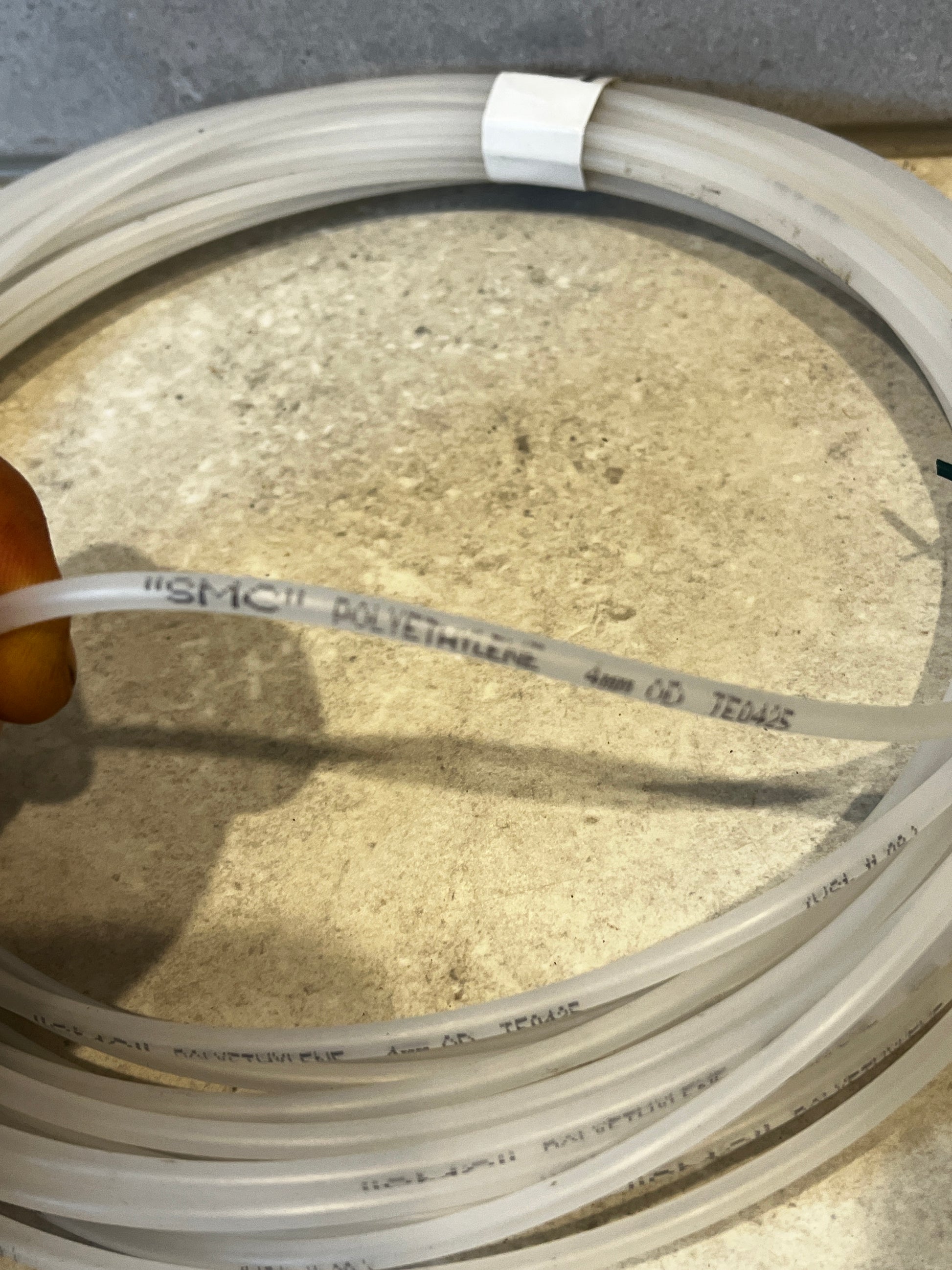 Close-up of transparent polyethylene tubing showing printed text and diameter