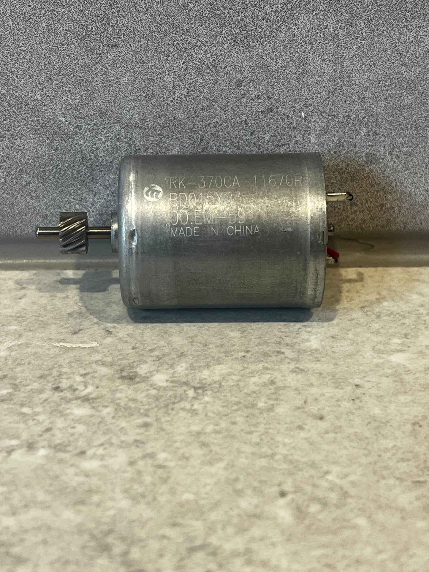 Top view of RK-370CA DC motor with engraved model number and electrical leads