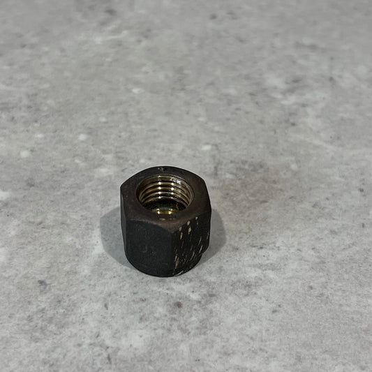 Close-up of a durable 1/4 inch metal flare nut on a neutral gray background for plumbing and HVAC use