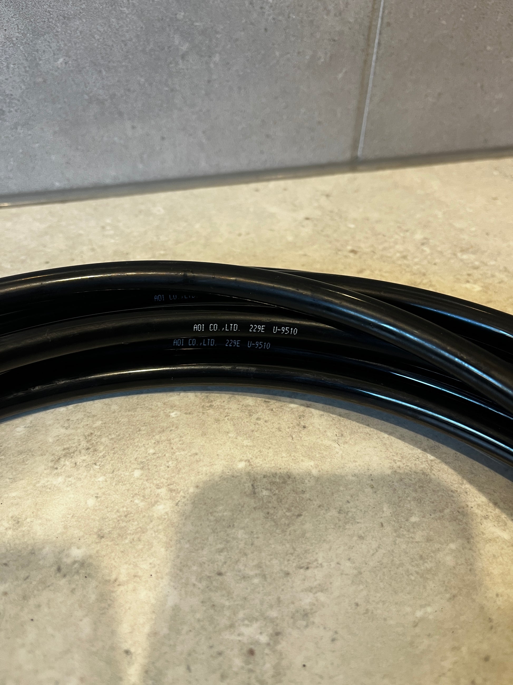 Close-up of durable black tubing with manufacturer markings