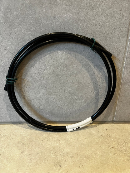 Black flexible tubing coiled with white label marked 1M