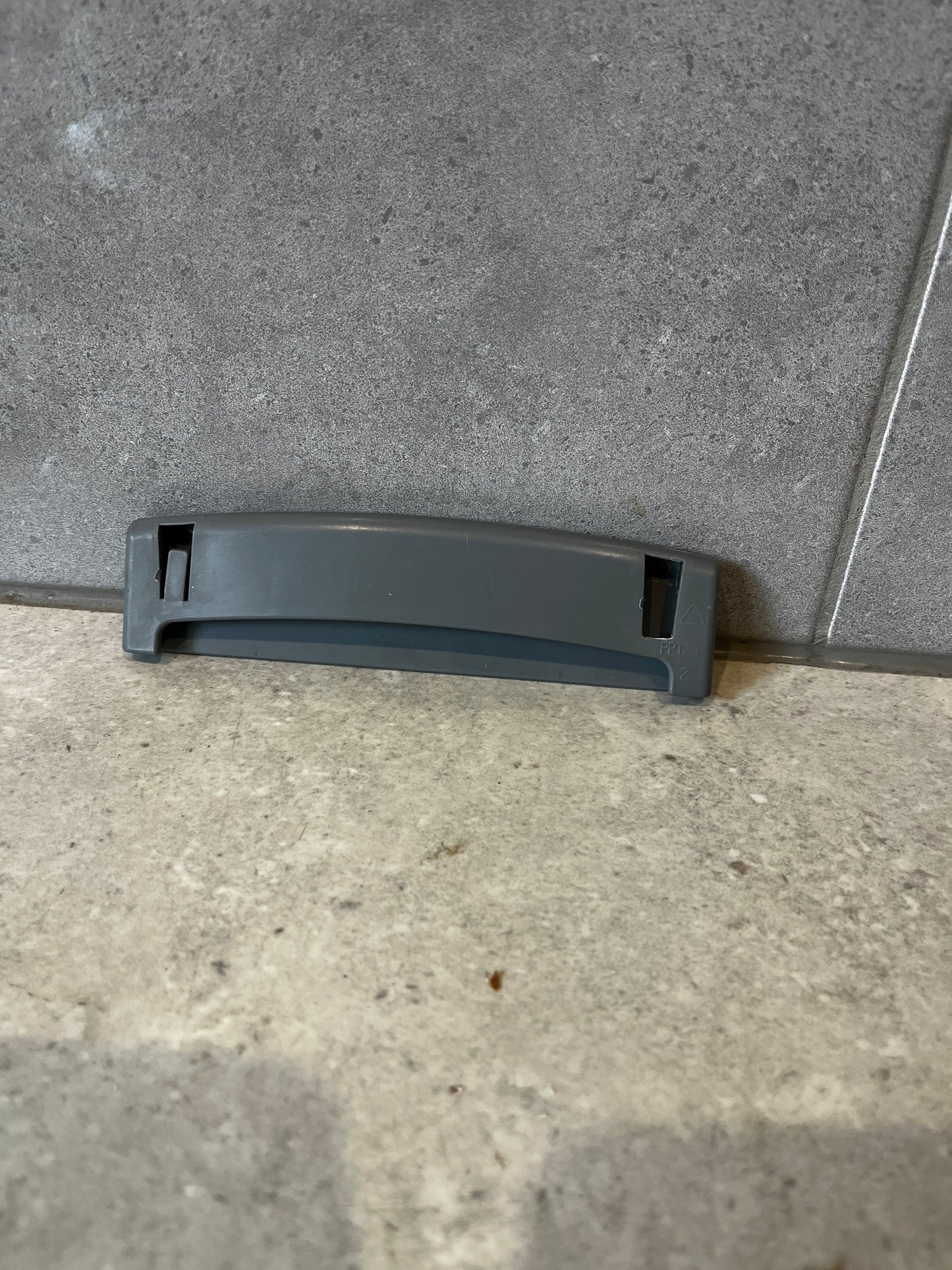 Back view of gray plastic replacement drawer handle showing attachment slots