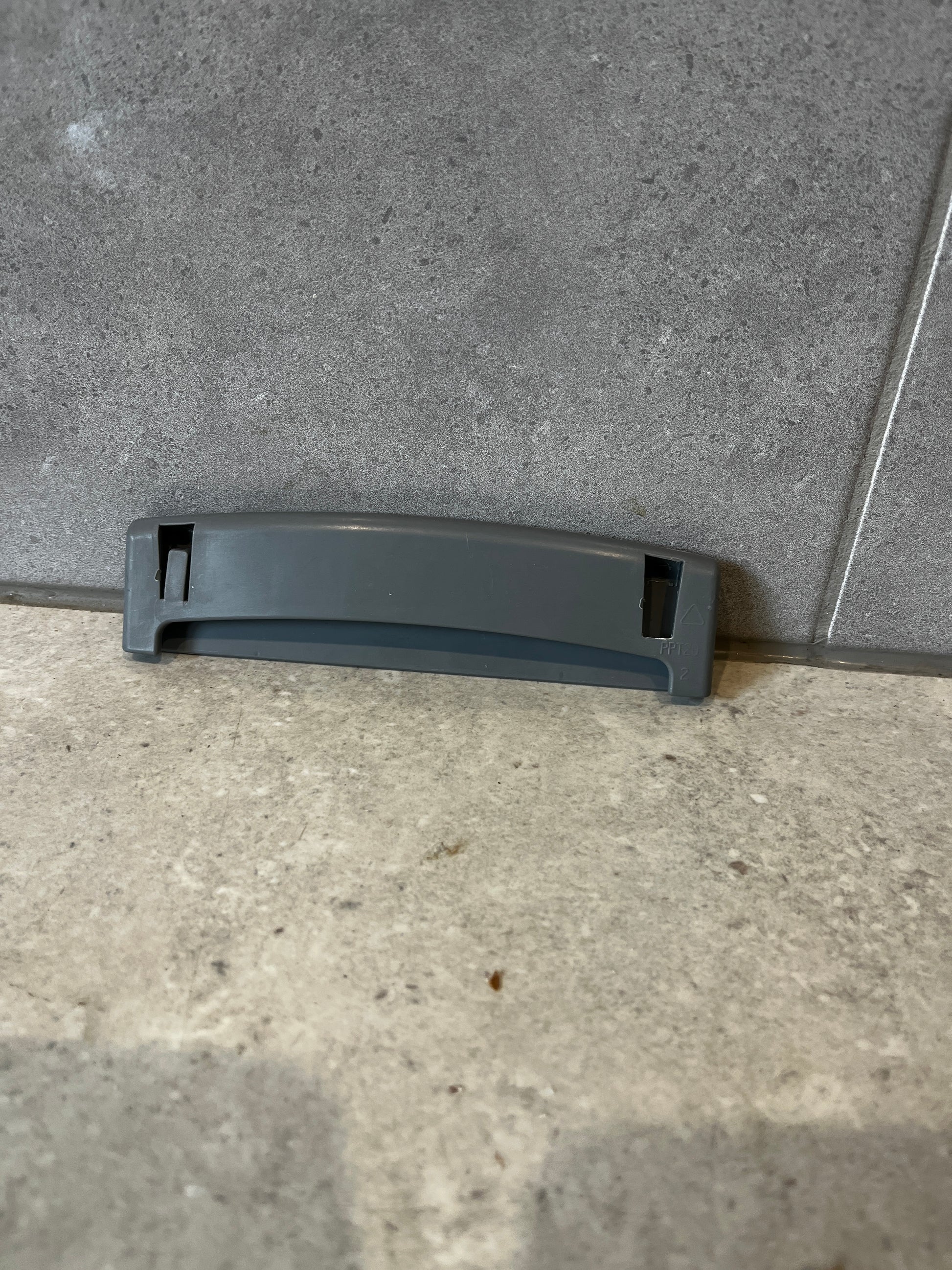 Back view of gray plastic replacement drawer handle showing attachment slots