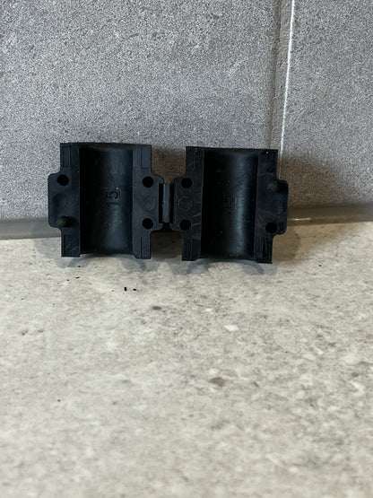 Front view of two black 15mm pipe clamps showing mounting holes