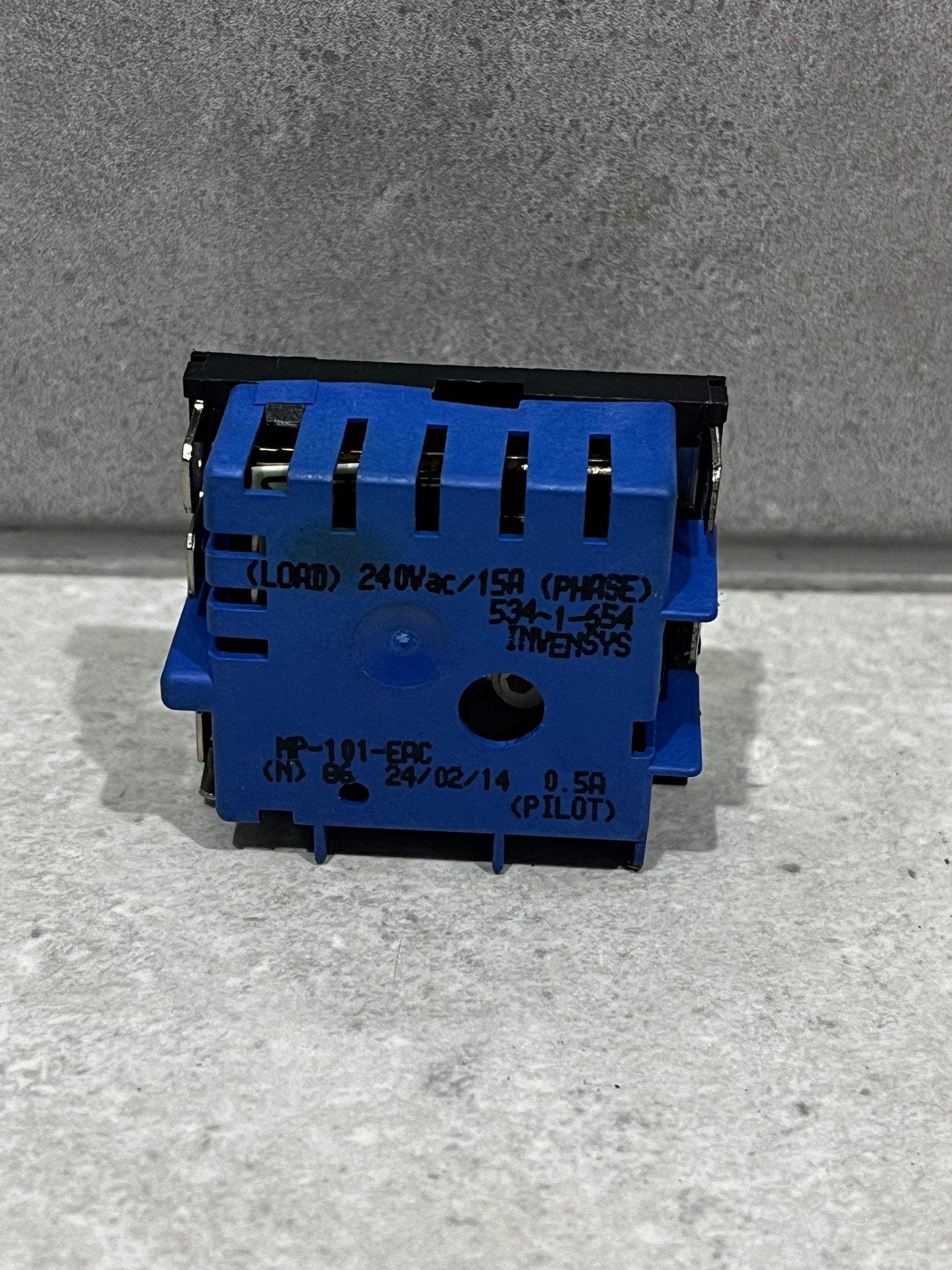 Back view of electronic toggle switch showing electrical rating and model information