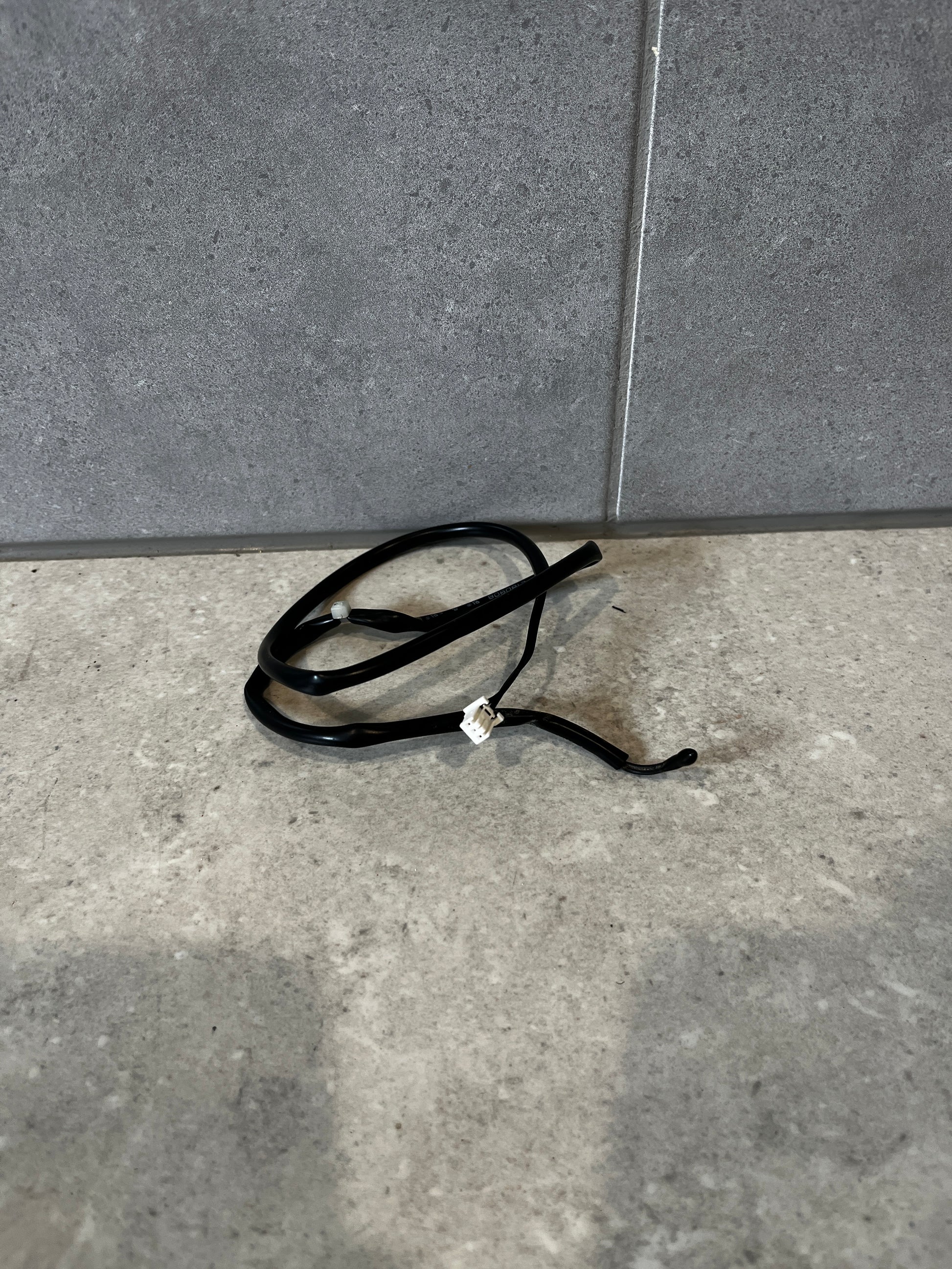 Waterproof temperature sensor with black cable and white connector