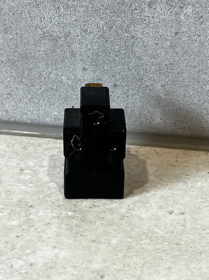 Rear view of black electrical relay switch showing terminals