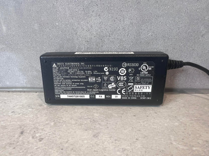 Close-up of Delta Electronics AC/DC adapter label with specifications