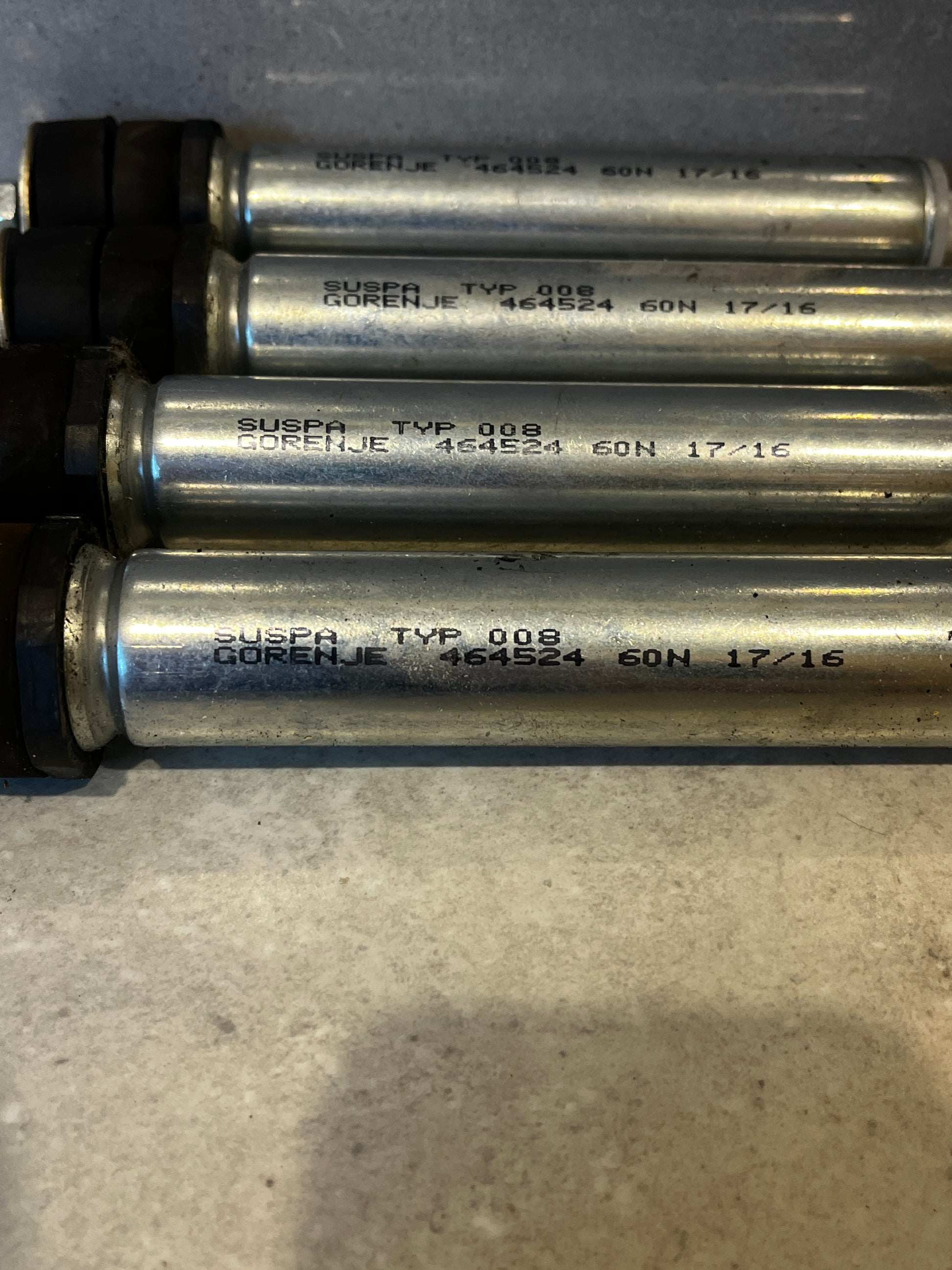 Close-up view of Gorenje SUSPA TYP 008 product markings on shock absorbers