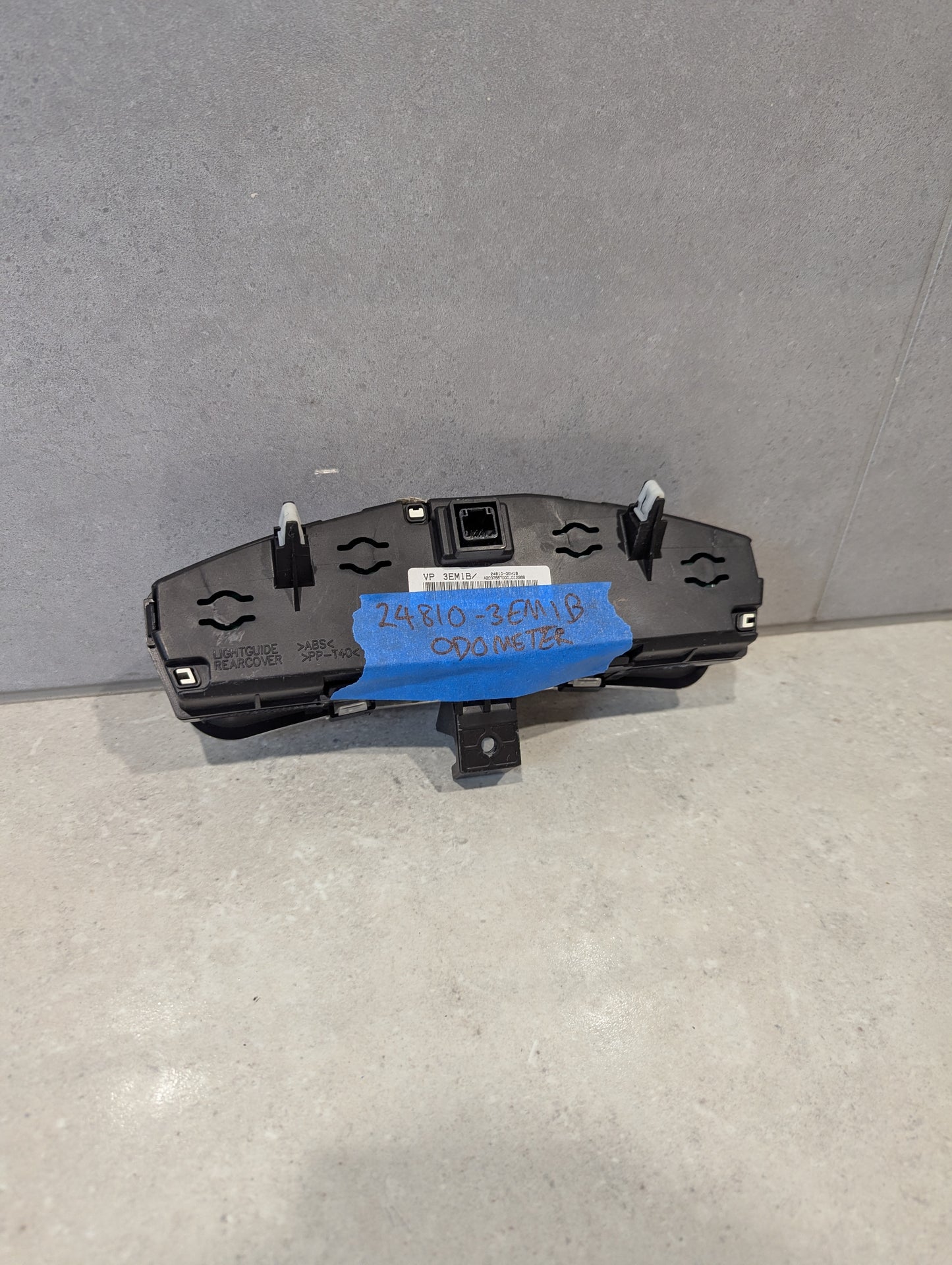 Rear view of digital car odometer display module showing connectors and label