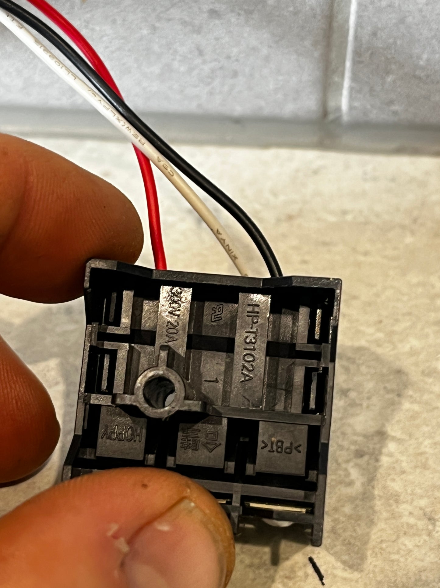 Close-up of three-wire terminal block connector showing terminal numbers and wire labels