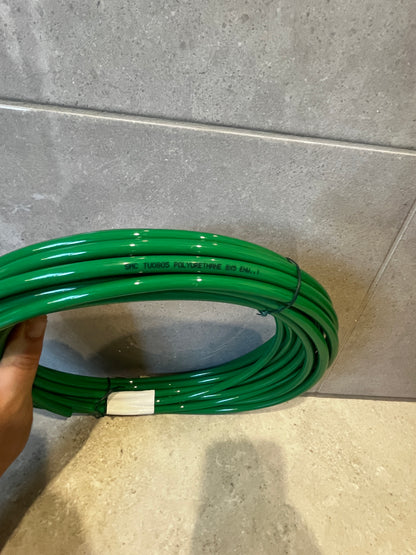 Close-up of green polyurethane tubing with product text printed on surface