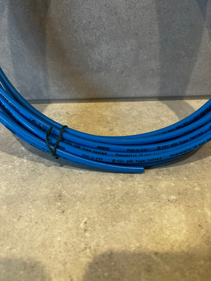 Close-up of blue pneumatic tubing with printed product specifications
