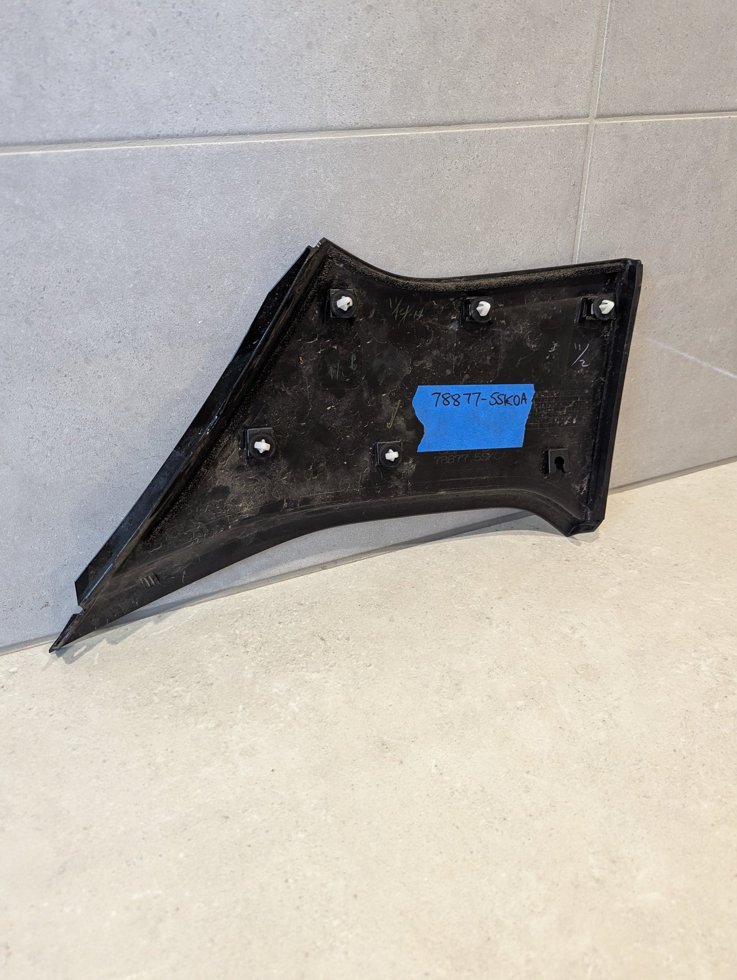 Reverse view of automotive plastic side panel showing part number 78877-5SK0A