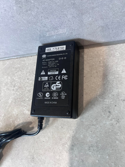 Close-up of SAN HUA 12V 4A AC adapter product label and certifications