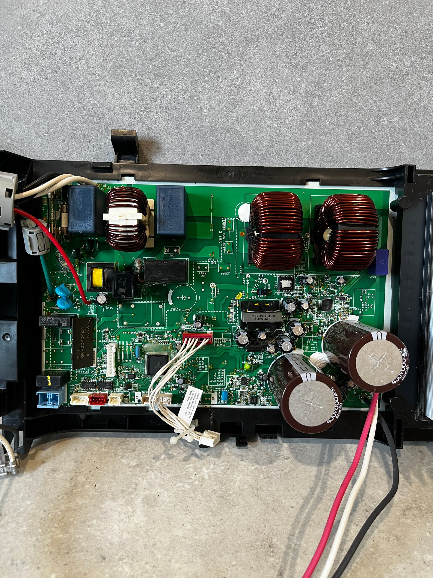 Close-up of electronic power control board and components including capacitors and coils
