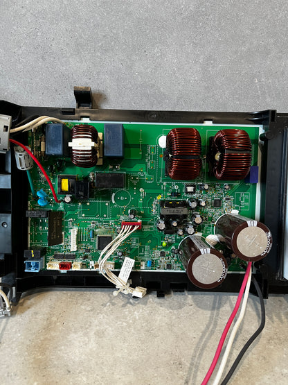 Close-up of electronic power control board and components including capacitors and coils