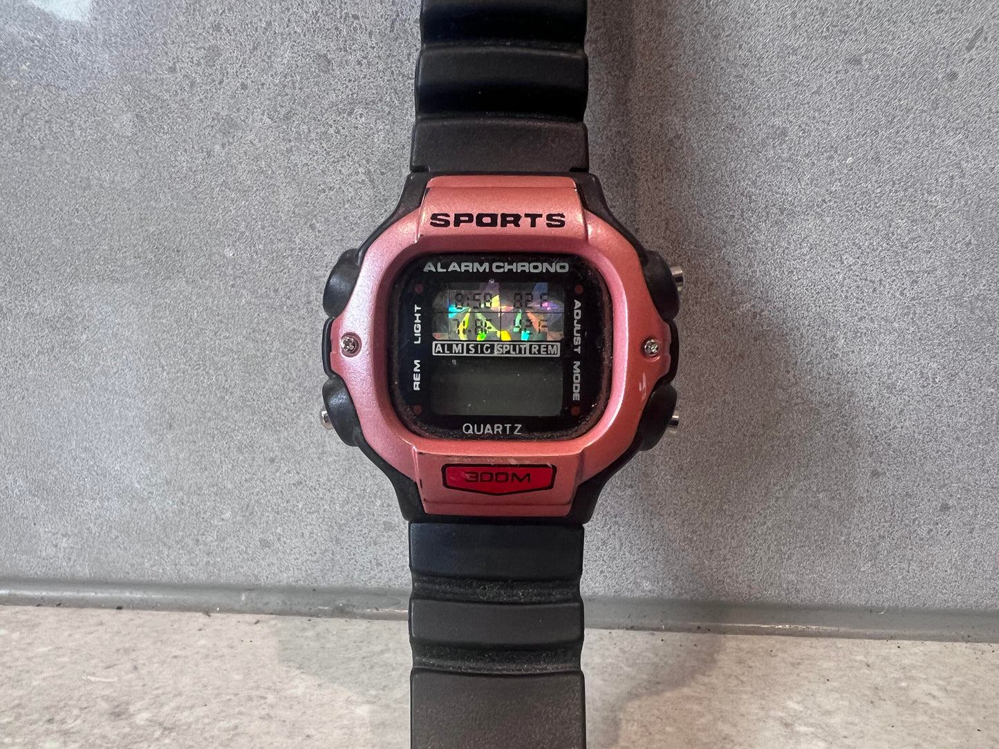Close-up of sports digital quartz watch face showing buttons and features