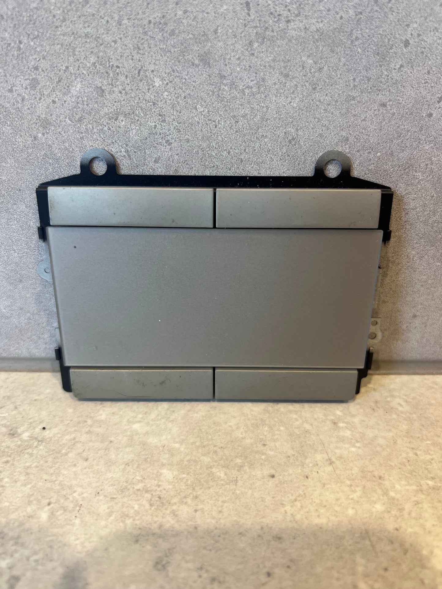 Laptop touchpad assembly front view showing four clickable sections