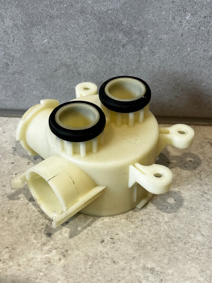 Top view of plastic water pump housing showing two O-ring sealed ports
