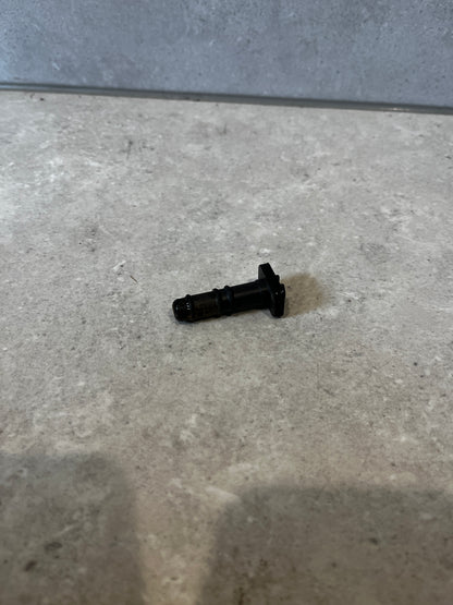 Black automotive injector valve on a countertop