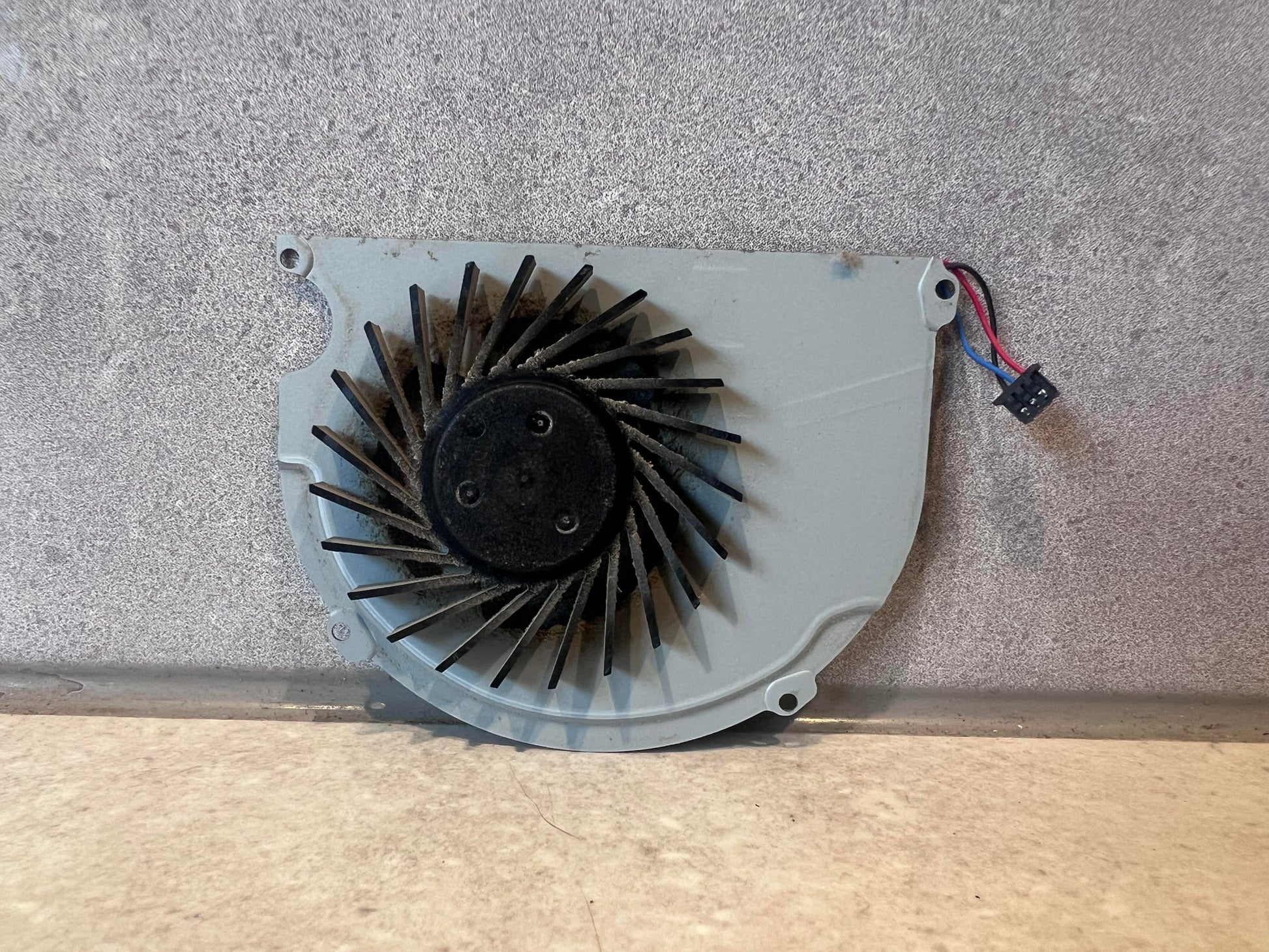 Reverse side of ADDA laptop cooling fan showing fan blades and connector