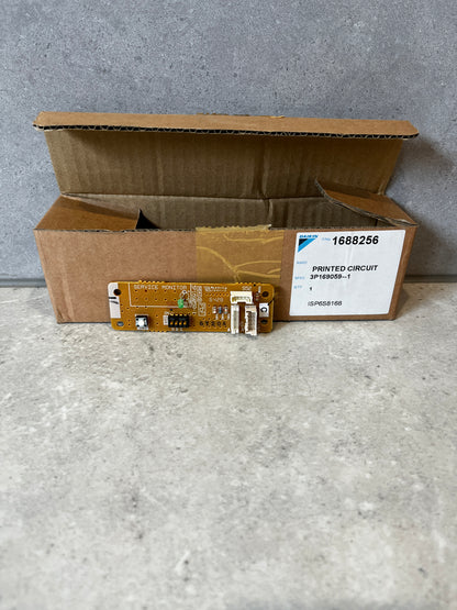 Daikin printed circuit board in front of open shipping box on gray surface