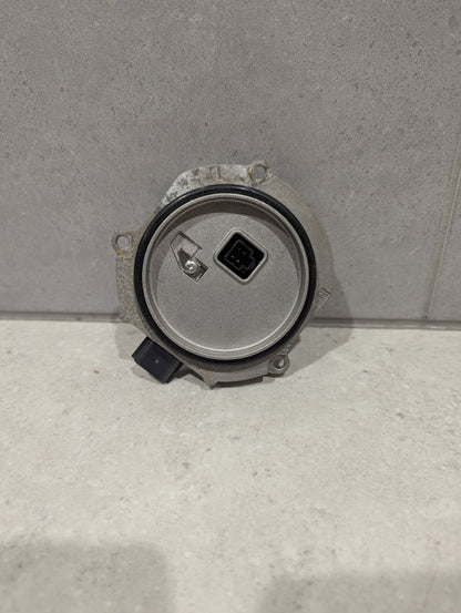 Back view of Ichikoh LED headlight control module showing circular housing and connector