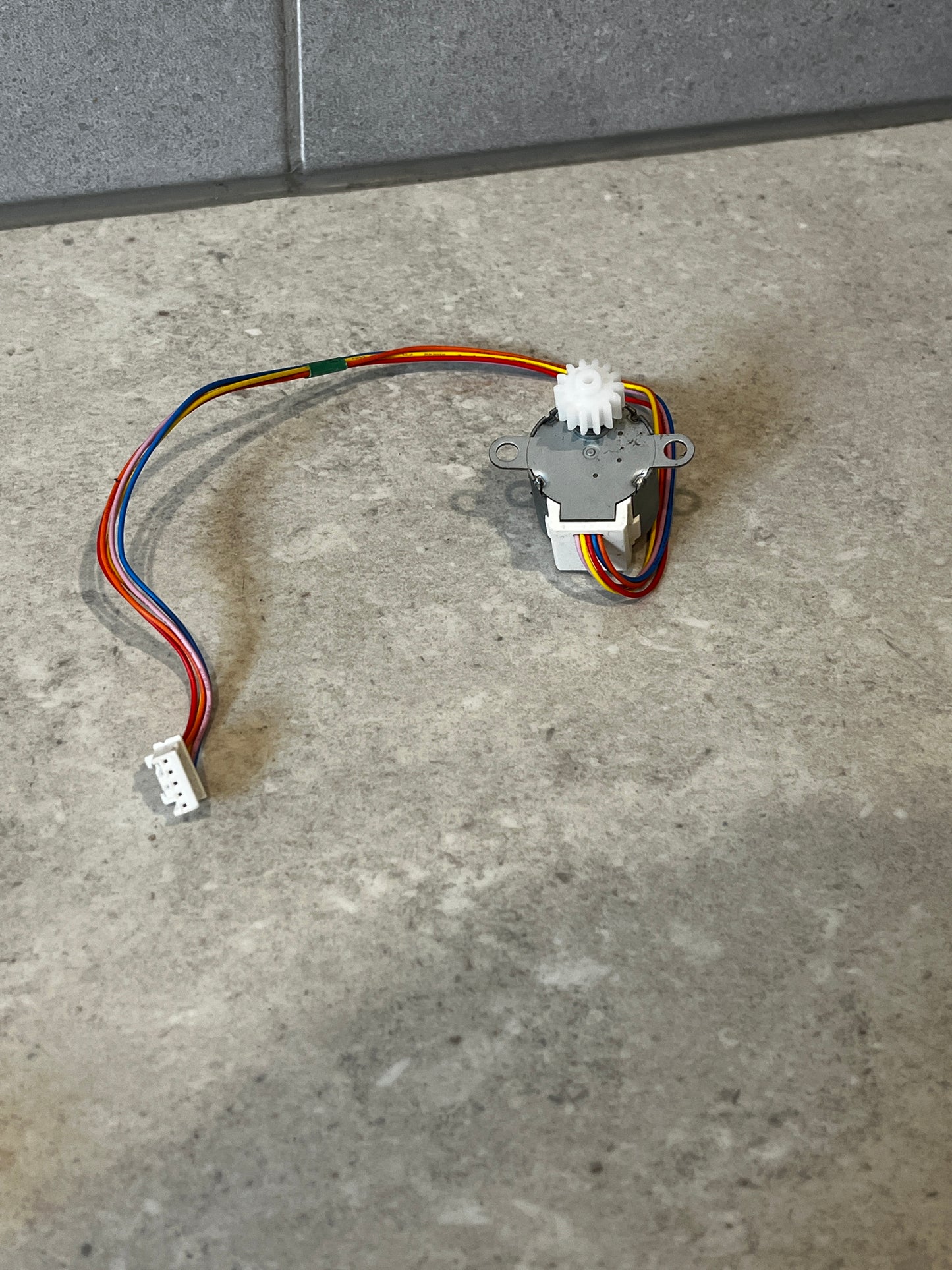 12V DC 24BYJ48 stepper motor showing gearbox, mounting holes, and attached wires