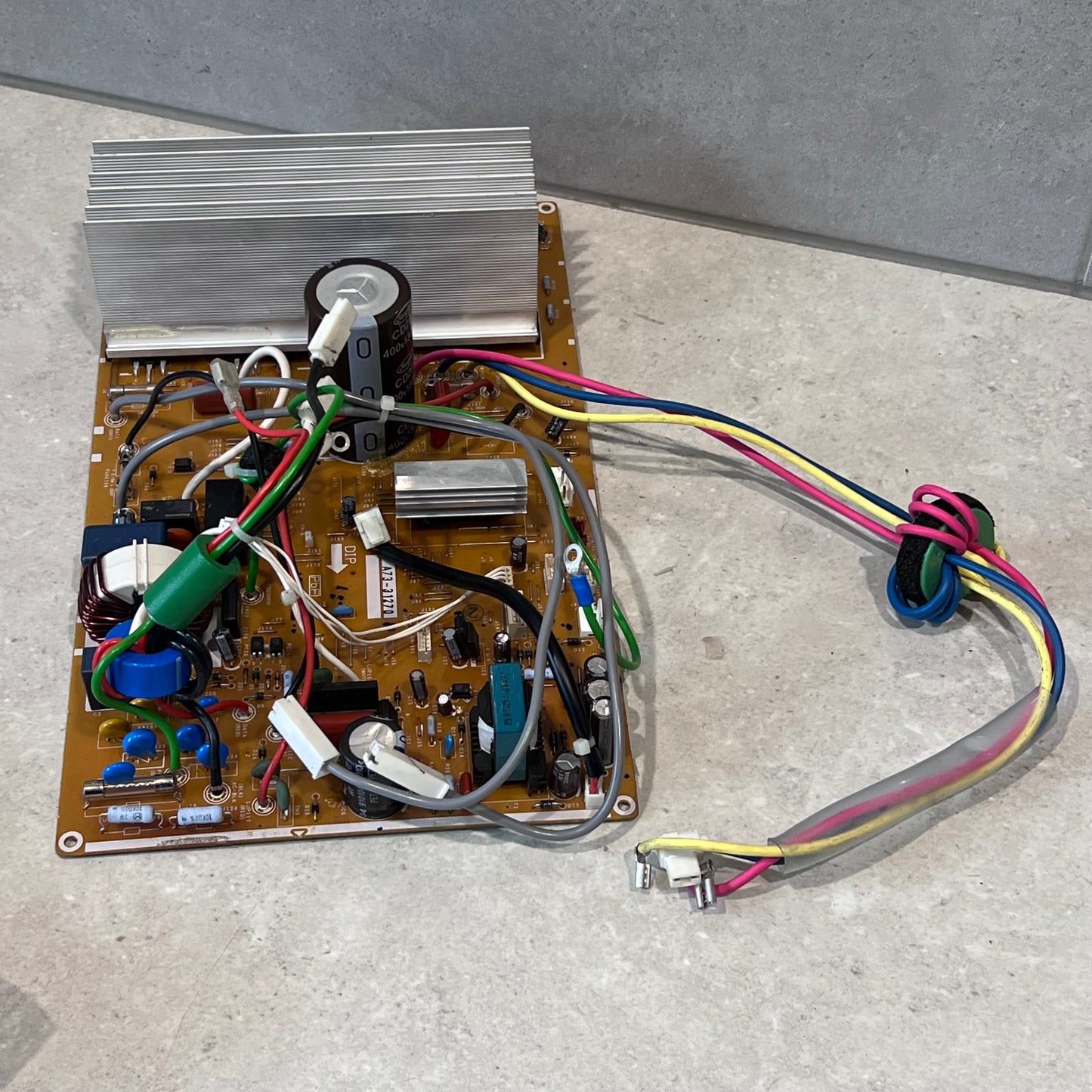 Side angle of ACXA73C55210R main PCB board showing wiring and large heat sink