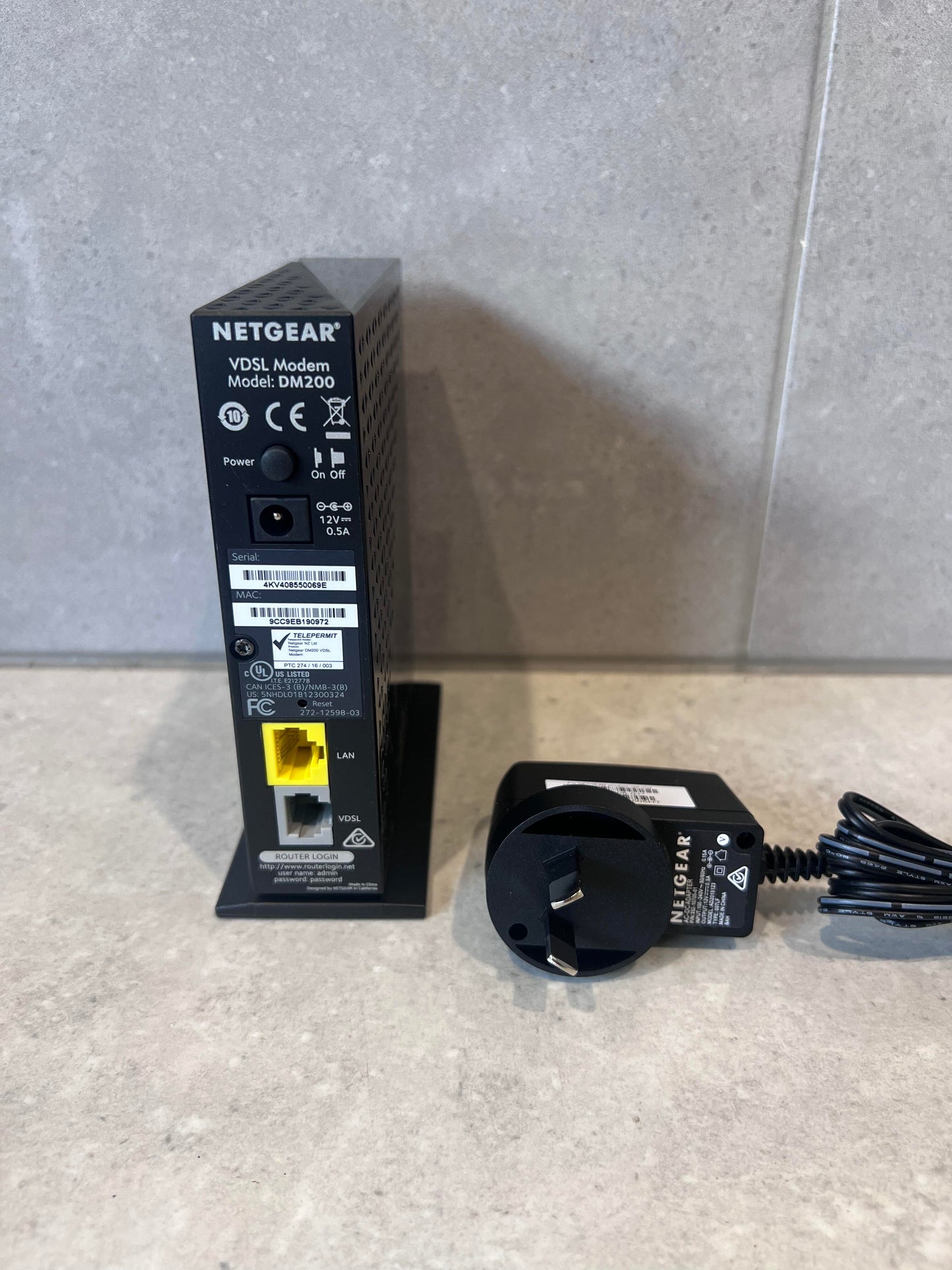 Rear view of NETGEAR DM200 VDSL modem showing ports and power adapter