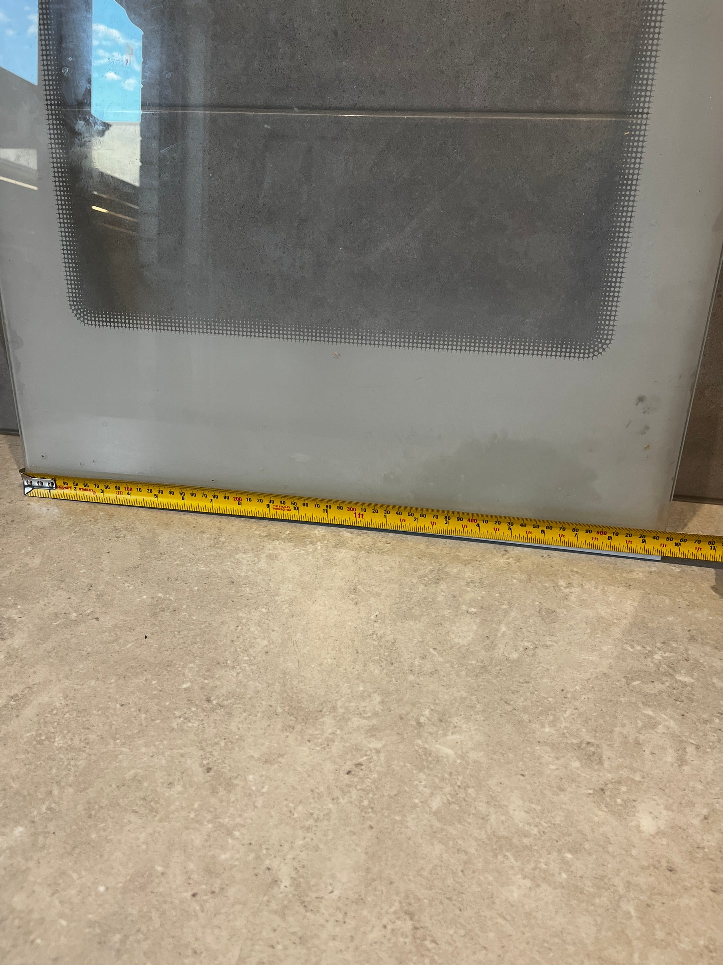 Fridge Glass  panel with visible measuring tape showing width dimensions