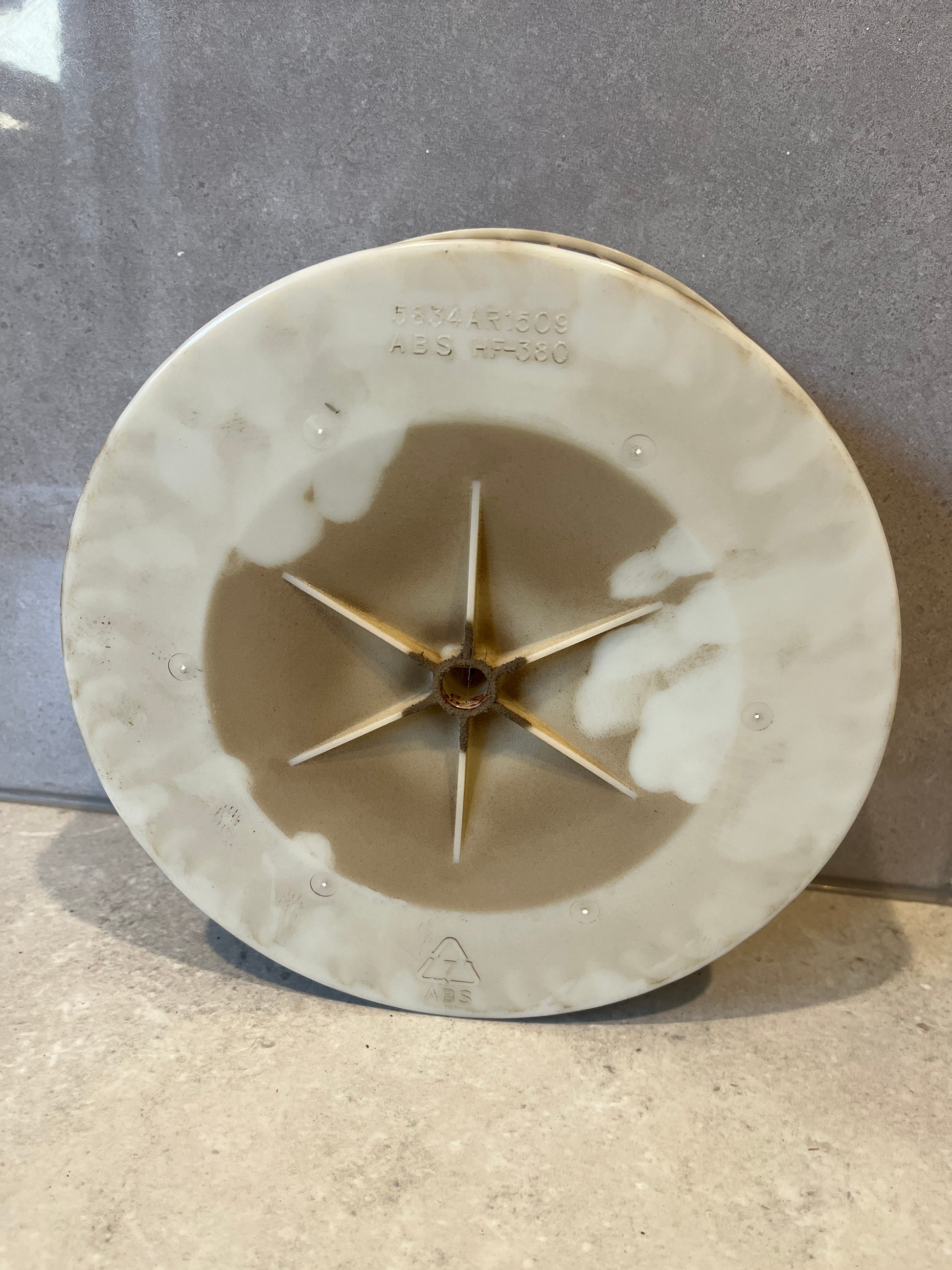 Bottom view showing ABS construction and mounting star-shaped hub of blower wheel