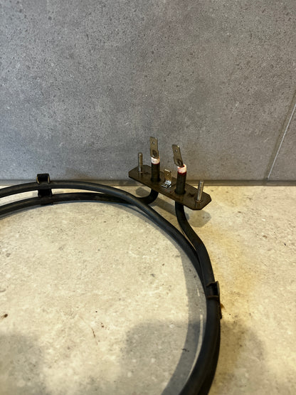 Detailed view of the heating element's two terminal connectors and mounting screws
