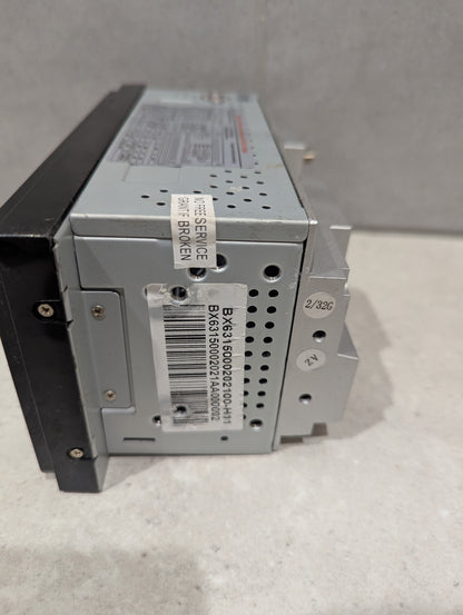Side view of car stereo head unit showing barcode and service sticker