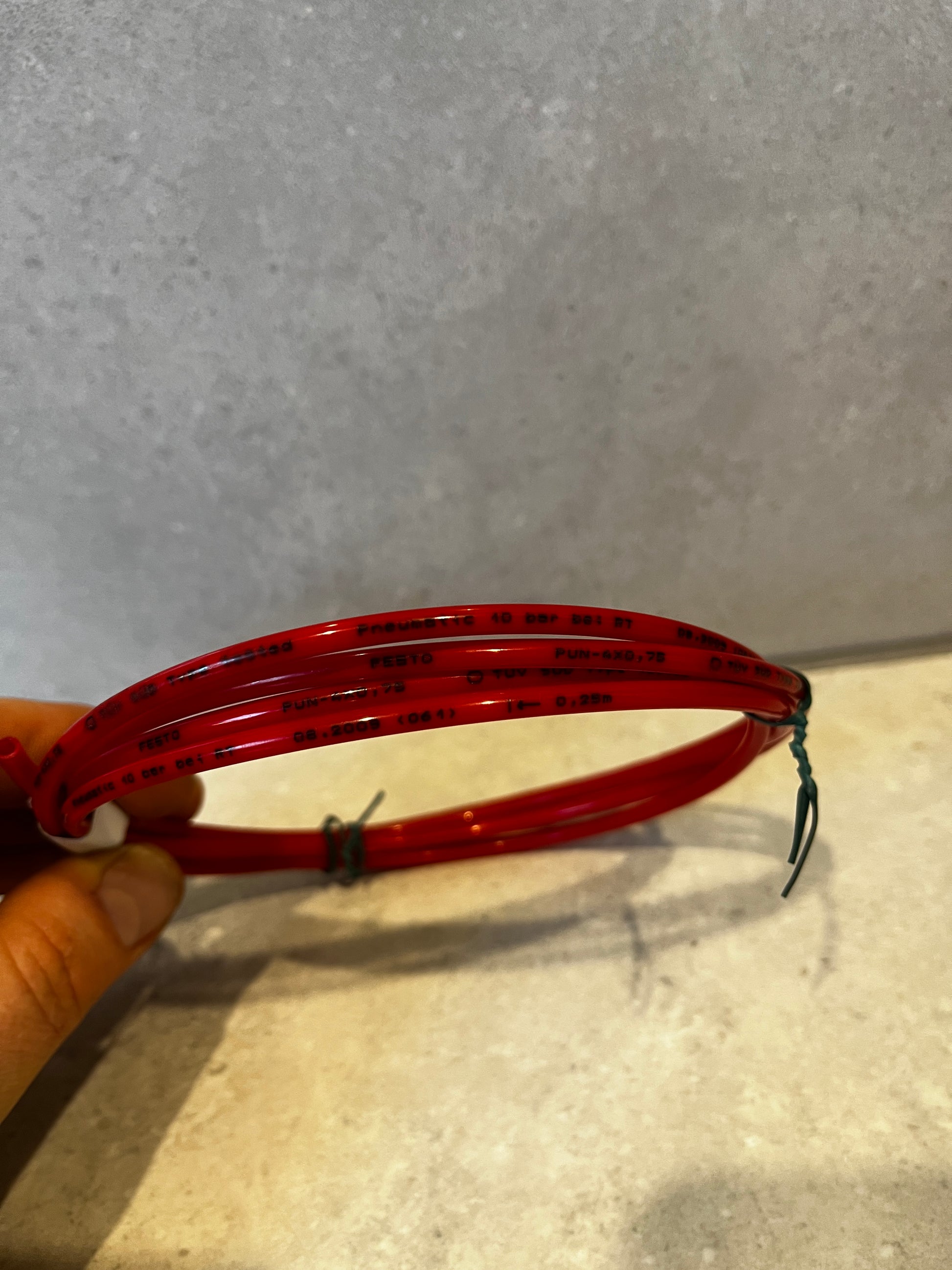 Detailed view of printed specifications on red pneumatic tubing coil