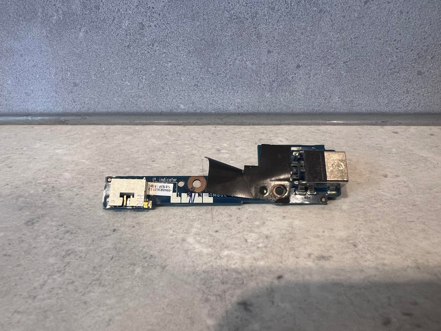 Reverse side of laptop USB port circuit board showing components