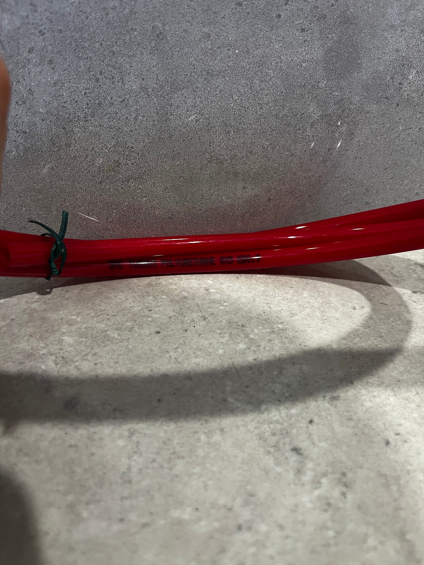 Side view showing text printed on red polyurethane tubing