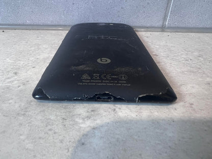 Bottom angle of HTC smartphone showing wear and charger port