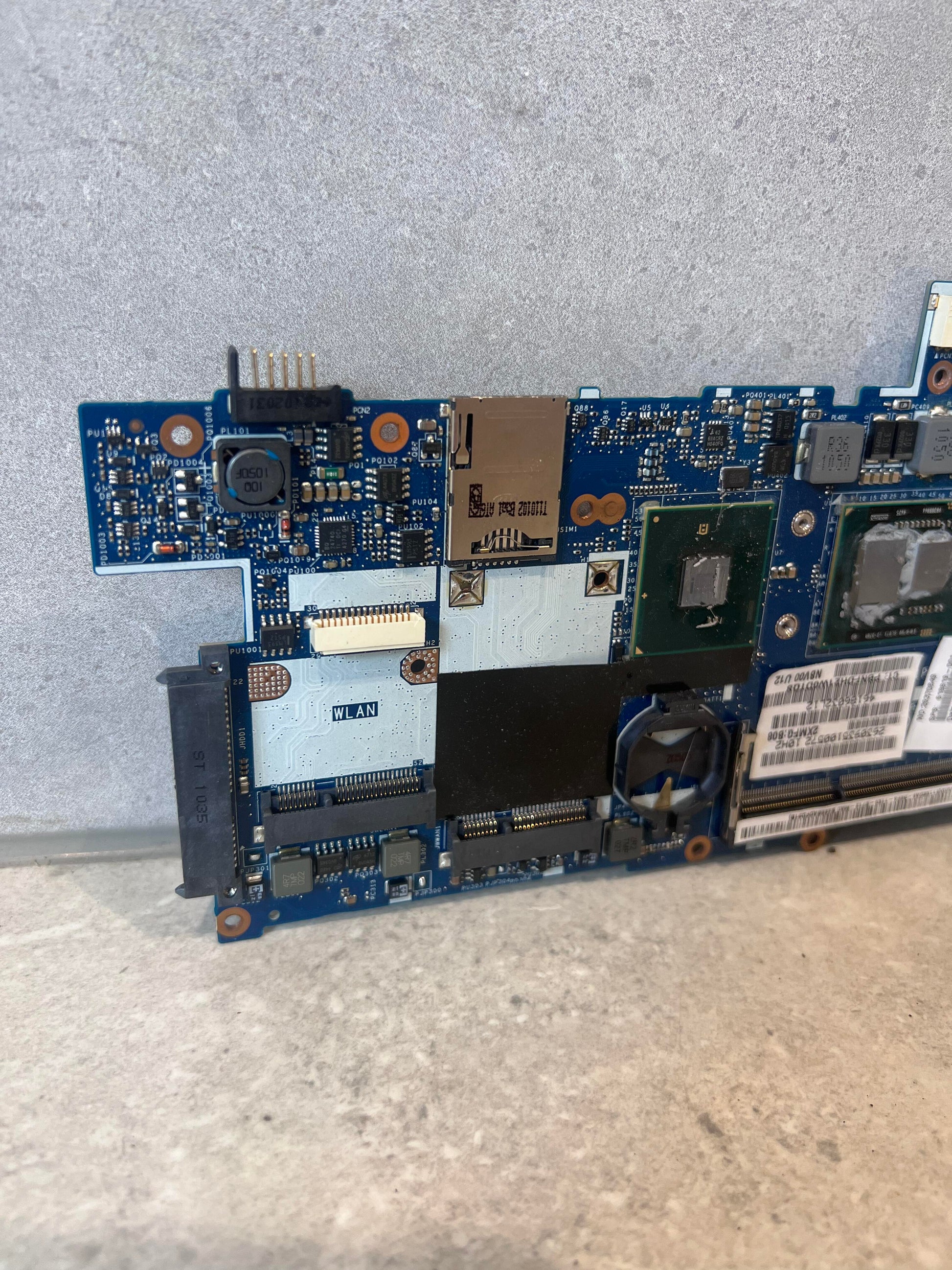 Close-up of WLAN slot and circuit details on Lenovo laptop motherboard