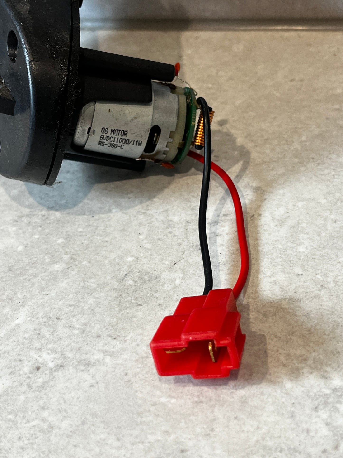 Close-up of motor and red two-pin electrical connector