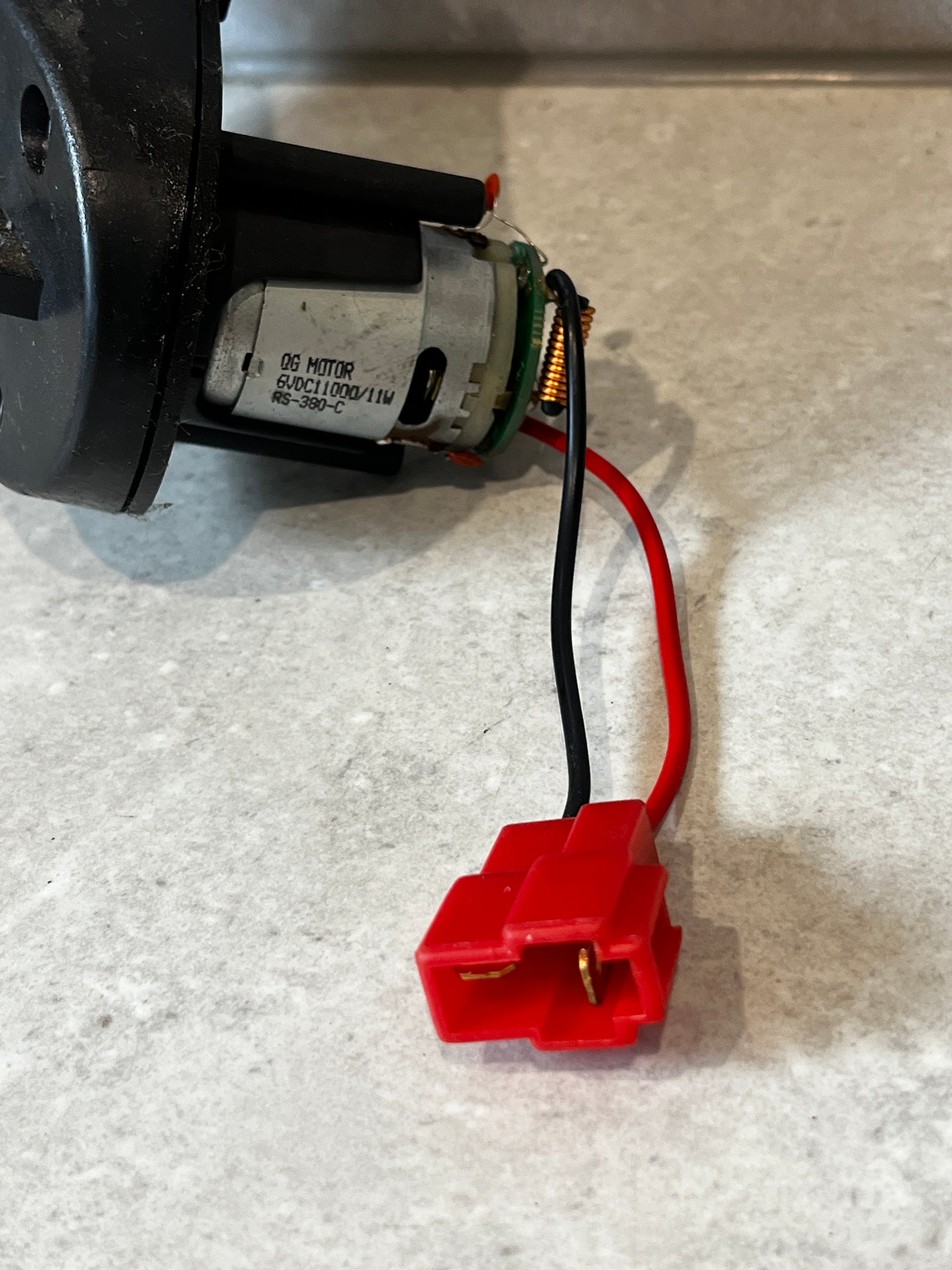 Close-up of motor and red two-pin electrical connector